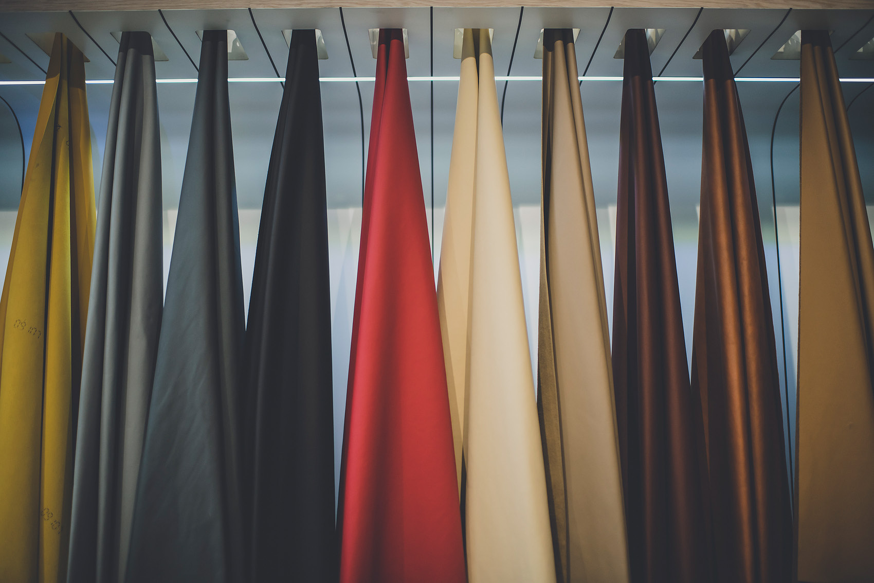Mulkol material colours displayed as hanging leather sheets