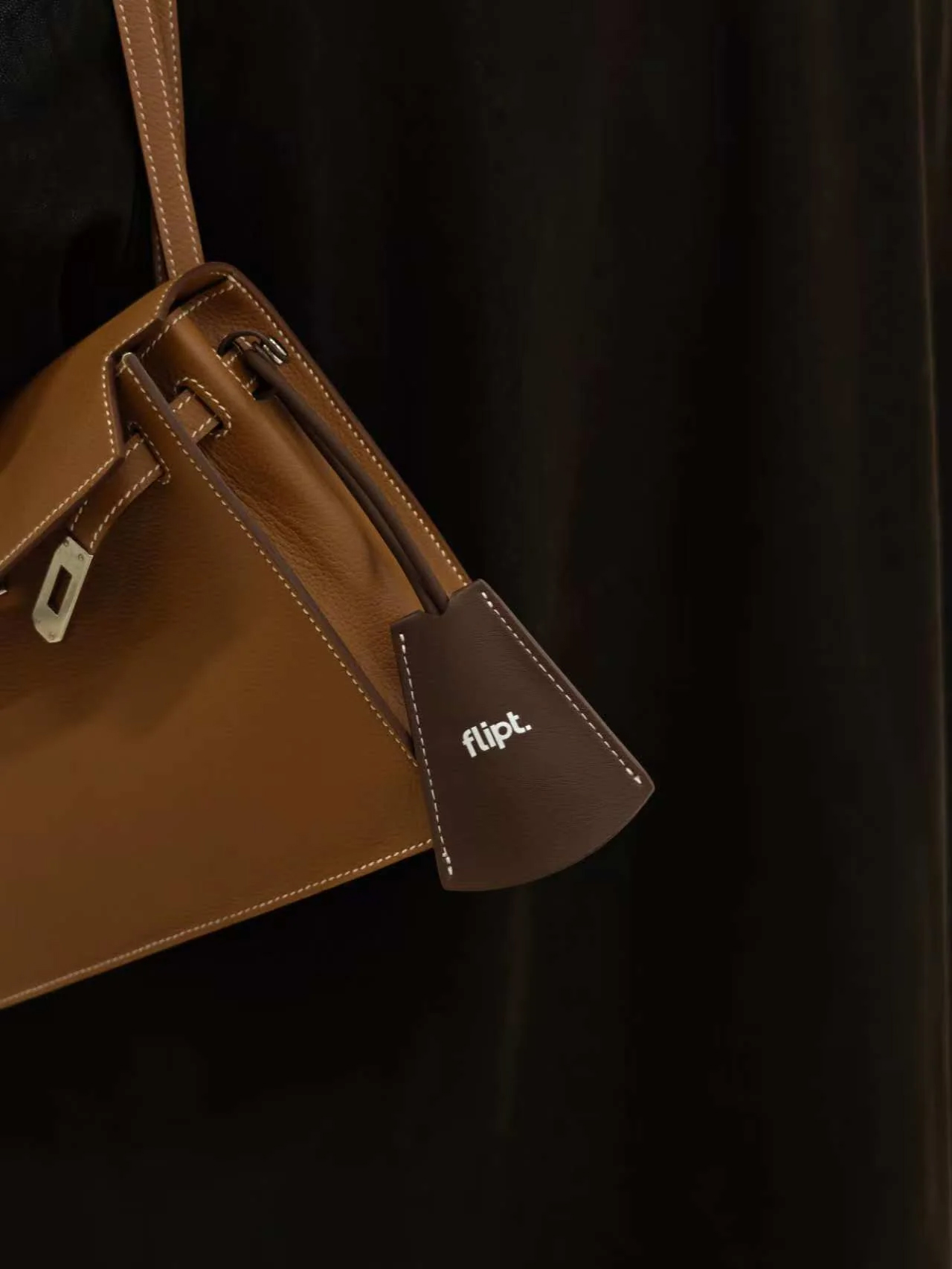 Brown Mulkol bag with a branded material tag